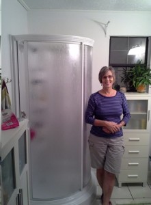 Pam johnson poses near a shower
