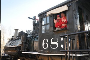 Children and father bidding goodbye from a train