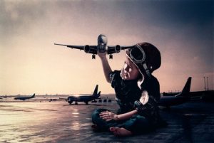 Edited picture of kid holding a huge aeroplane