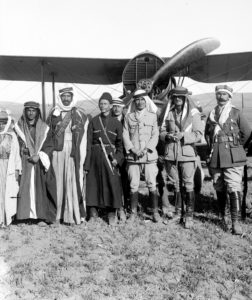 Group of people standing before a plane