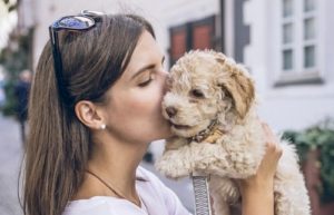Woman kisses a dog