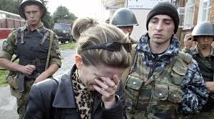 A woman cries while being rescued by the military men