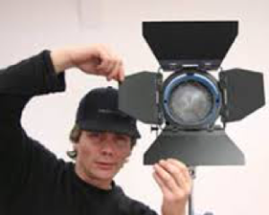 Man operating a light for the camera
